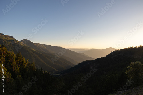 Fototapeta Naklejka Na Ścianę i Meble -  Landscape of the forest covered mountain range at sunset or sunrise