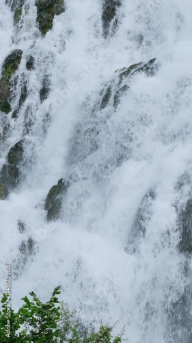 White water cascades gently down the rocks. Slow-motion close-up of a waterfall. photo