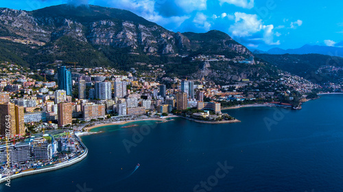 Breathtaking aerial view of Monaco featuring its modern skyline, coastal beauty, and lush mountains. Perfect for travel, architecture, and luxury lifestyle visuals.