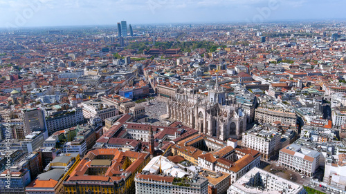 Breathtaking aerial view of Milan, Italy showcasing the iconic Duomo Cathedral surrounded by historic buildings and modern architecture. Perfect for travel, urban visuals, and cultural landmarks.
