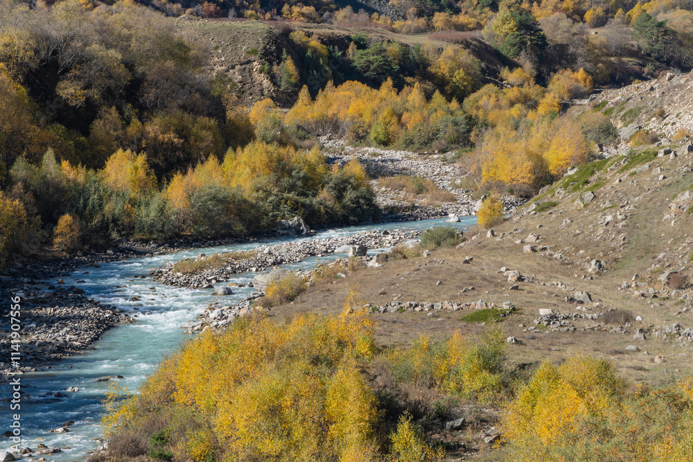 Stormy and foaming emerald waters of Chegem River flow between steep cliffs with grottoes created by nature. Chegem River in means 