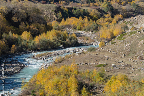 Stormy and foaming emerald waters of Chegem River flow between steep cliffs with grottoes created by nature. Chegem River in means 
