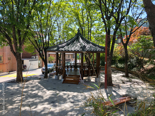 A wooden pavilion structure offering a peaceful resting spot, blending harmoniously with its natural surroundings. photo