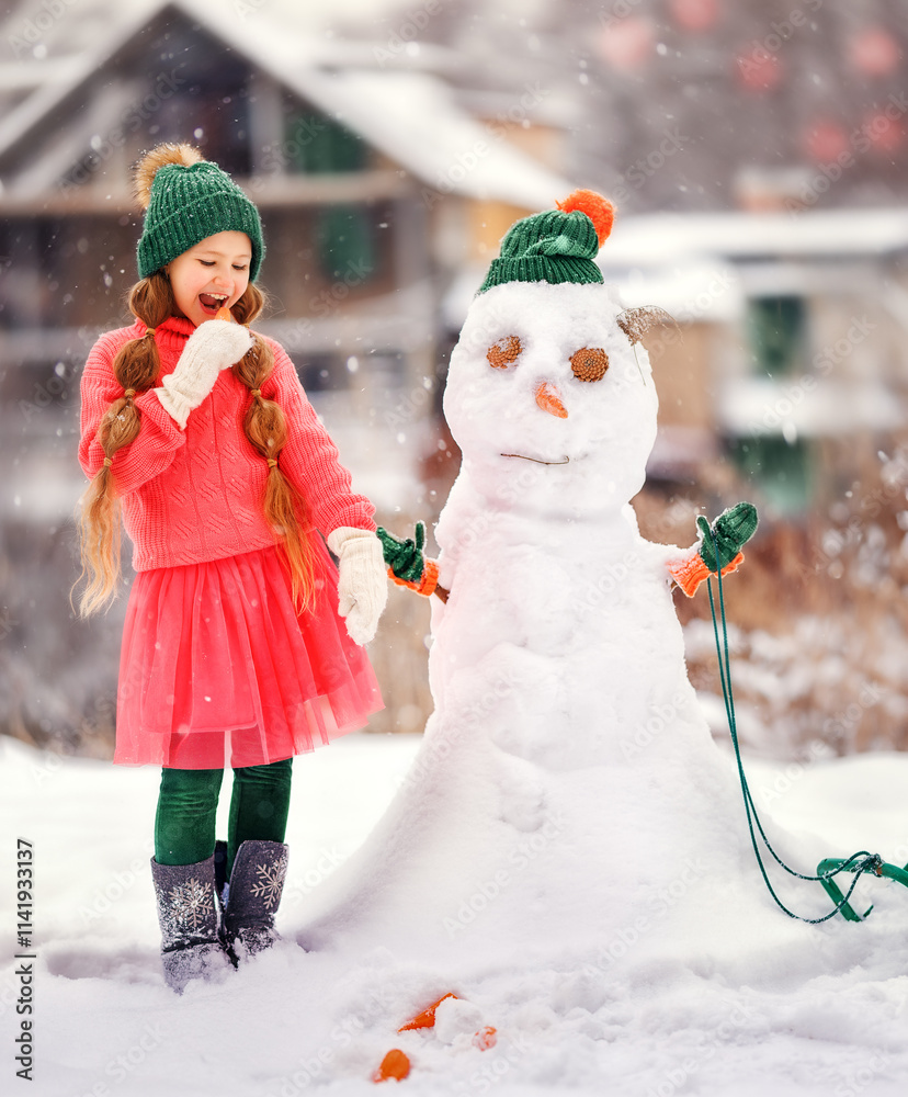 Kid girl makes snowman on winter frosty day. Child makes nose out of carrot. Outdoor family fun on Christmas vacation in the winter new year