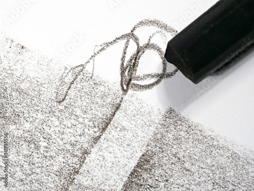 used and broken  crayon on black and white painted paper background