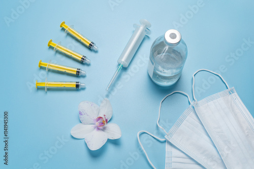 Wallpaper Mural Big and small syringes with a bottle for liquid medicine and medical masks. Torontodigital.ca
