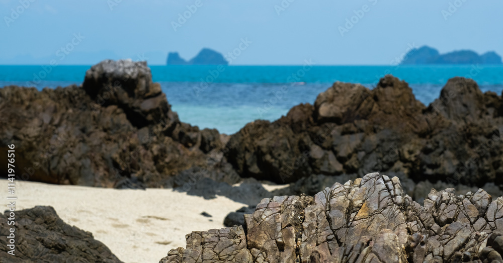 A rocky beach on Koh Samui, Thailand, featuring rugged volcanic rocks, soft sand, and a turquoise sea. A rocky beach on Koh Samui, Thailand, featuring rugged volcanic rocks, soft sand, and a turquoise sea.