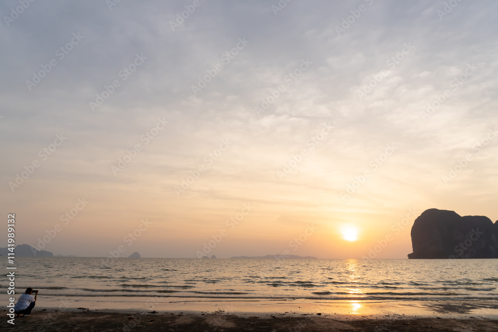 Beautiful morning or evening blue and orange sky while sunsets or sunrises at the sea with woman taken at the beach used as natural blackground texture