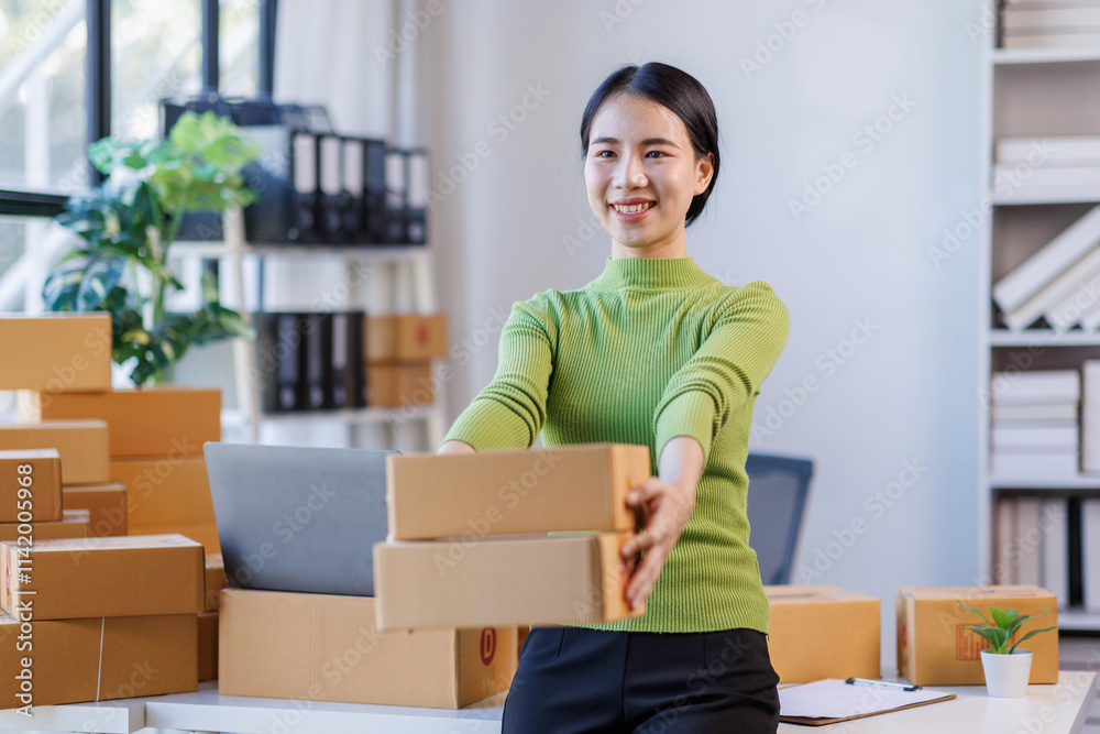 Happy young asian woman SME startup small business freelance work on parcel box and laptop computer Prepare to deliver items to customers , Online marketing packing box delivery SME e-commerce concept Happy young asian woman SME startup small business freelance work on parcel box and laptop computer Prepare to deliver items to customers , Online marketing packing box delivery SME e-commerce concept