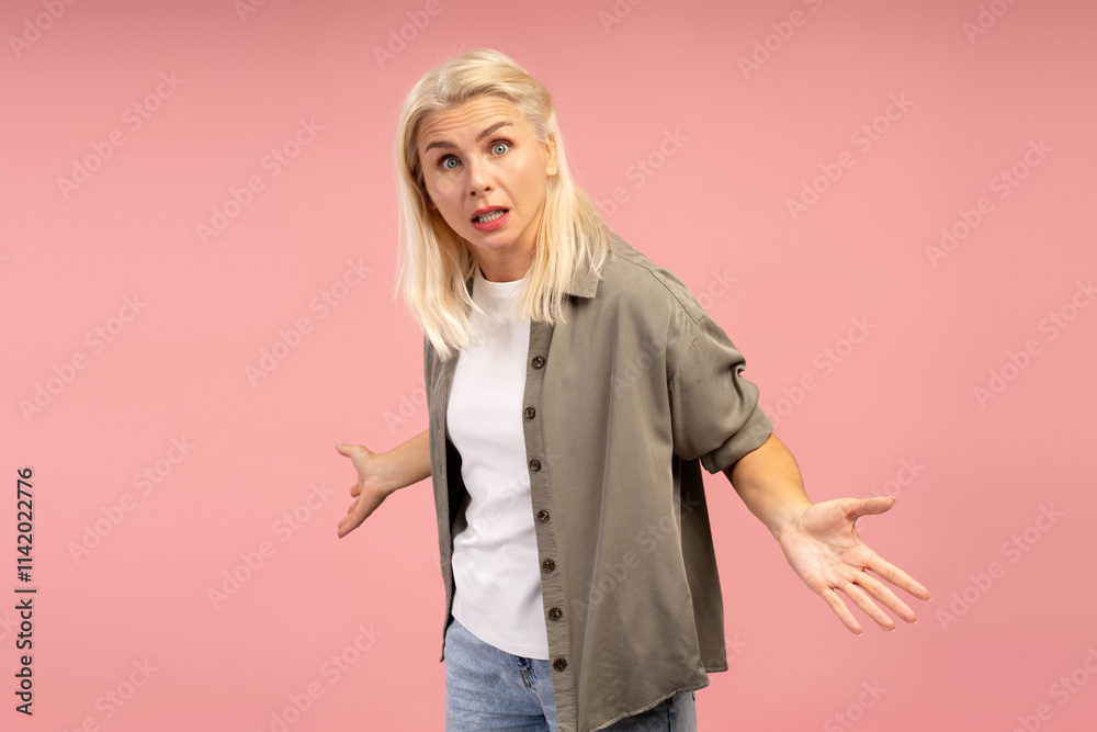 Puzzled woman shrugging shoulders on pink background Puzzled woman shrugging shoulders on pink background