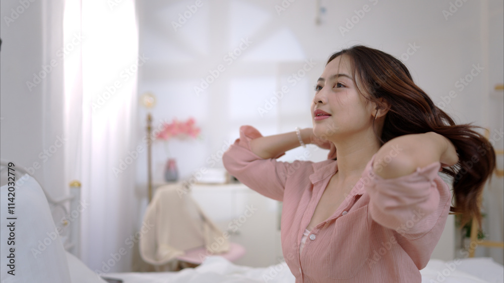 Asian young woman relaxing before bedtime on the bed in the bedroom Asian young woman relaxing before bedtime on the bed in the bedroom