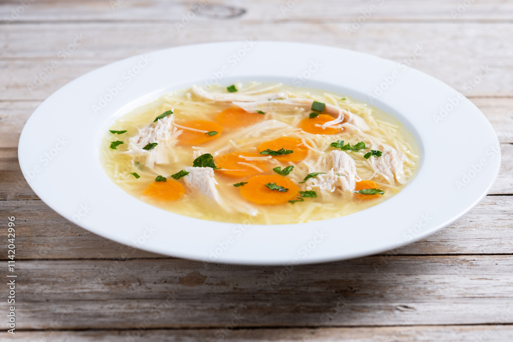 Homemade chicken soup on wooden table Homemade chicken soup on wooden table