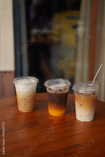 many cup of ice coffee on the wood table