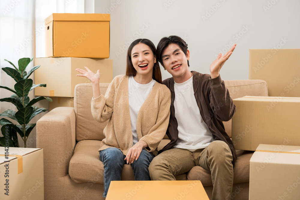 Couple asian family buying new house. Happy moment man and woman getting new home moving parcels into the house and decorate Moving relocation with lot of parcel box cardboard Couple asian family buying new house. Happy moment man and woman getting new home moving parcels into the house and decorate Moving relocation with lot of parcel box cardboard