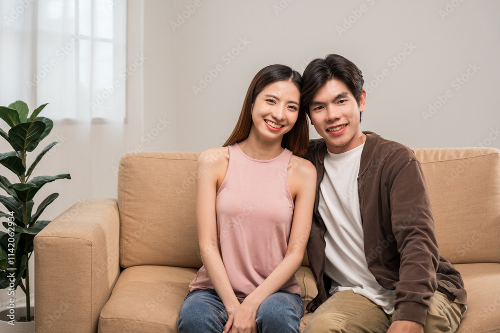 Happy moment of asian family man and woman husband and wife just married buying new house. Relax on sofa in living room Happy moment of asian family man and woman husband and wife just married buying new house. Relax on sofa in living room