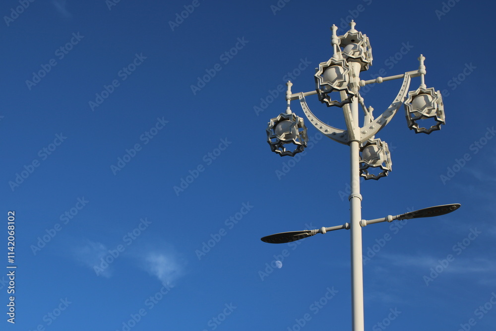lamp post against blue sky with moon lamp post against blue sky with moon
