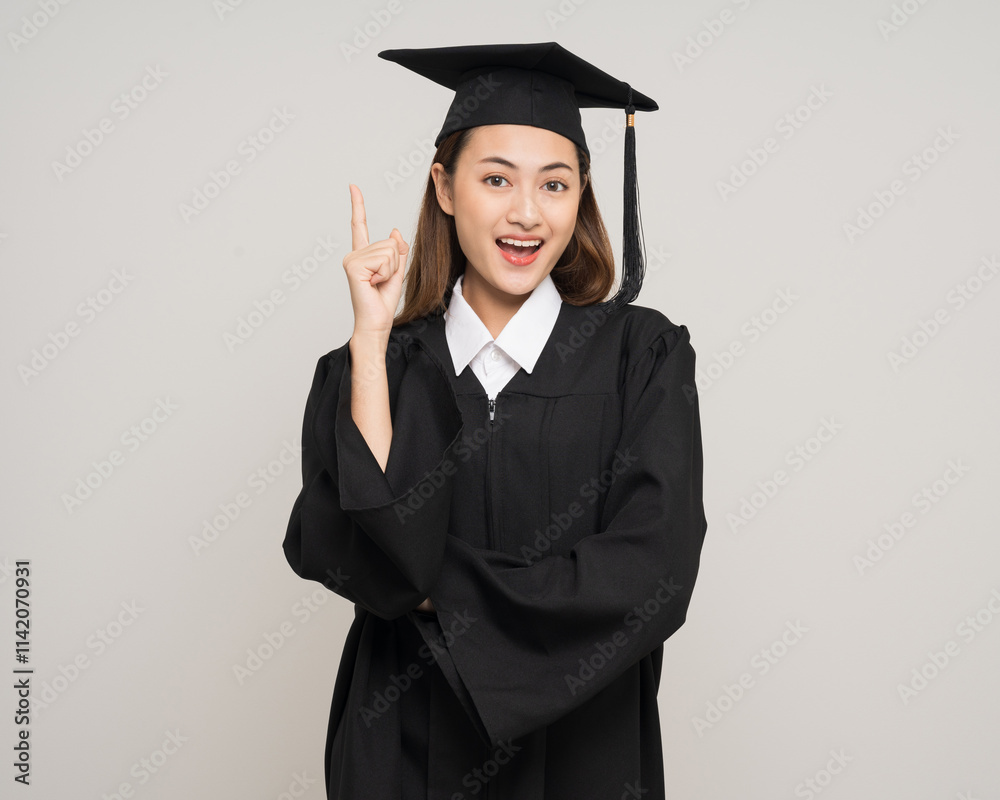 Happy asian woman in graduation costume with cap on isolated background. College degree successful education graduation in university Happy asian woman in graduation costume with cap on isolated background. College degree successful education graduation in university