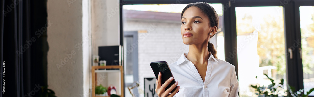 A young Black businesswoman in a white shirt stands in a modern office, holding her phone, banner A young Black businesswoman in a white shirt stands in a modern office, holding her phone, banner
