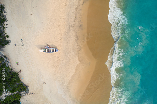 Ariel drone view of a seashore or beach area with boat, Nice bluish color and mesmerizing scene of ocean and nature