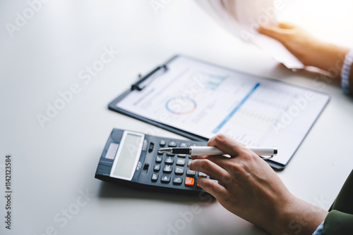 Portrait of a young woman calculating the bill for expenses to be paid. Financial concepts, debt repayment and bank finance.