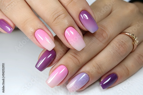 Ombre nail polish showcasing a soft gradient with shades of pink and purple on well-groomed hands