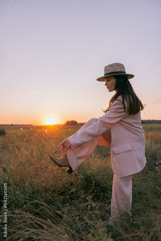 Young pretty woman walking on meadow through herbs at sunset. Young pretty woman walking on meadow through herbs at sunset.