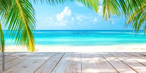 Fototapeta Naklejka Na Ścianę i Meble -  Beach with a palm tree in the foreground and a blue ocean in the background