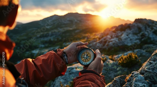 Fototapeta Naklejka Na Ścianę i Meble -  An explorer using a compass to navigate a rocky mountain landscape at sunset