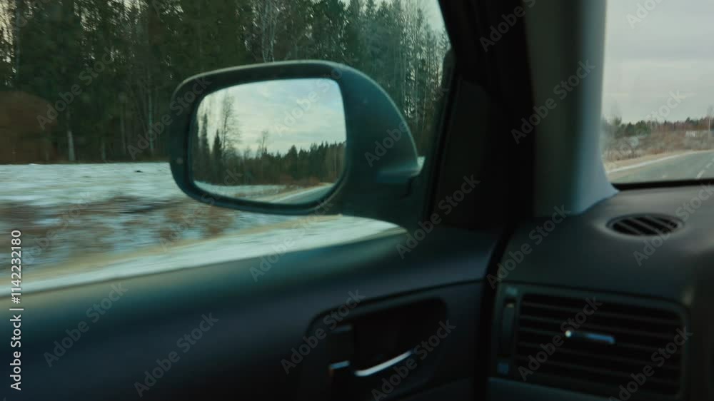A breathtaking scenic drive is experienced through a stunning winter landscape, seen in the side mirrors reflection A breathtaking scenic drive is experienced through a stunning winter landscape, seen in the side mirrors reflection
