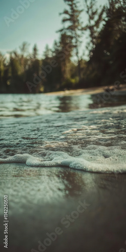 Tranquil Forest Lake Shore with Gentle Waves at Sunset