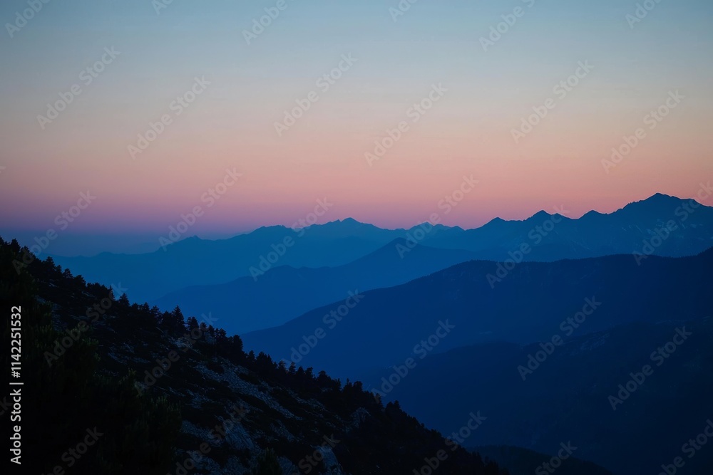 The outline of mountains at dawn with a vibrant sky. Ossola, Italy. The outline of mountains at dawn with a vibrant sky. Ossola, Italy.