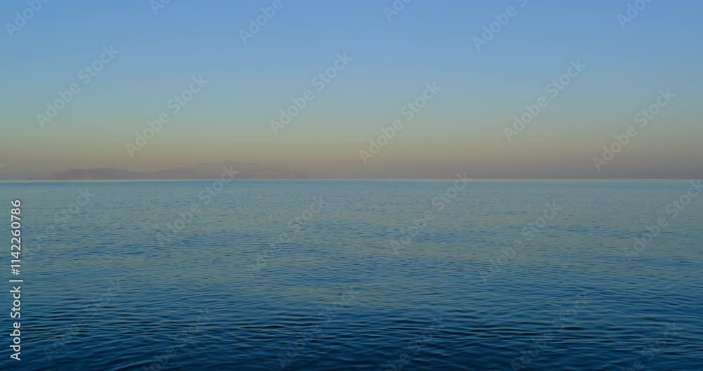 Aegean Sea surface and horizon in morning dawn. In Güzelçamlı, Kuşadası, Aydın, Turkey Aegean Sea surface and horizon in morning dawn. In Güzelçamlı, Kuşadası, Aydın, Turkey
