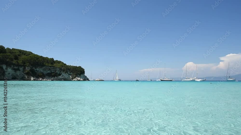 HD video of the bay of the island of Antipaxos in Greece from the beach. Boats moored in a crystal clear sea under a clear sky. Perfect destination for lovers of travel, relaxation and nature HD video of the bay of the island of Antipaxos in Greece from the beach. Boats moored in a crystal clear sea under a clear sky. Perfect destination for lovers of travel, relaxation and nature