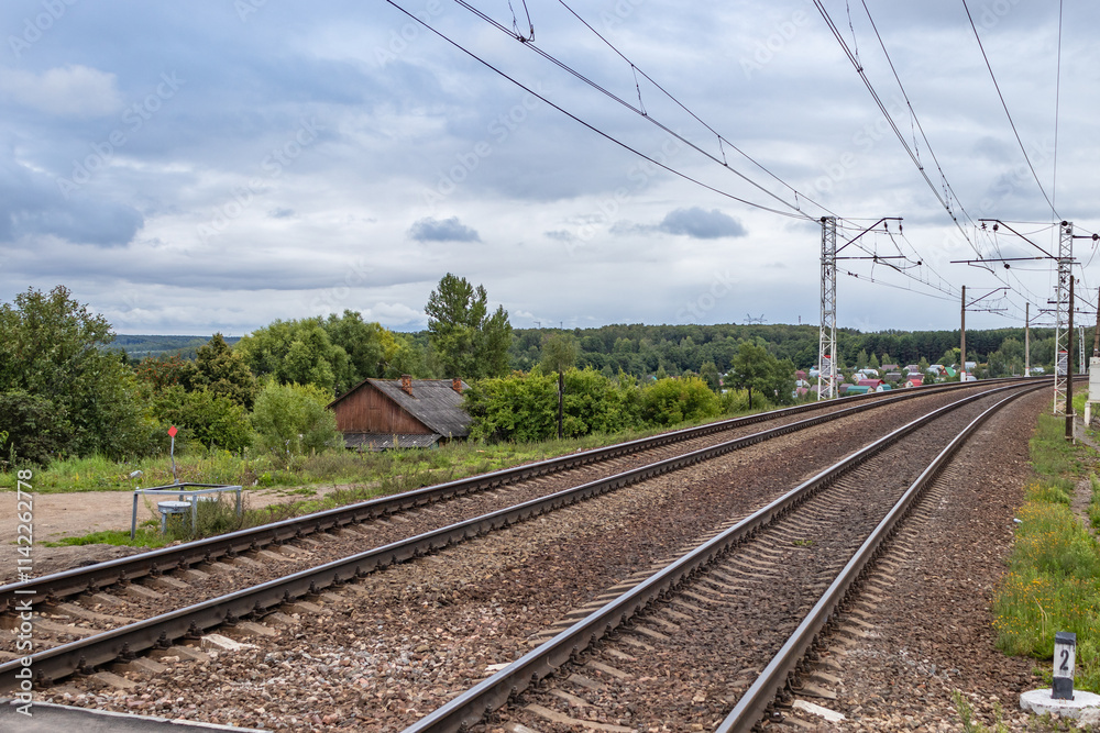 Railway in Tula region, Russia. landscape with railway track, sky with clouds, trees and grass. railway junction. travel. nobody. transportation. Railway in Tula region, Russia. landscape with railway track, sky with clouds, trees and grass. railway junction. travel. nobody. transportation.