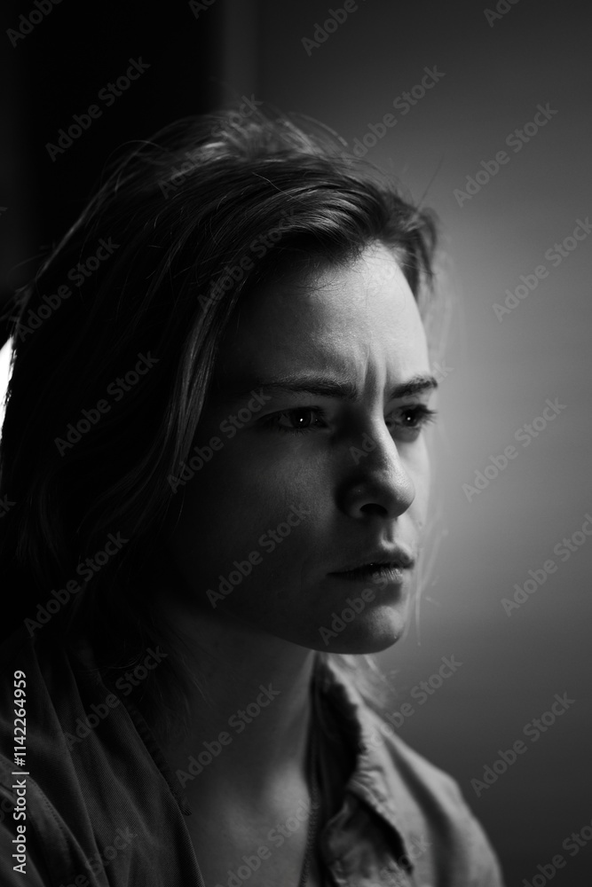 Black and white art portrait girl blonde short hair emotionally frowning serious expression on the background of the apartment Black and white art portrait girl blonde short hair emotionally frowning serious expression on the background of the apartment