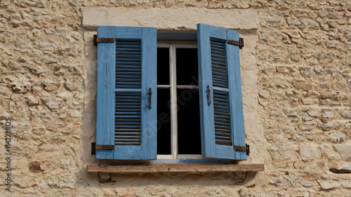 Wooden Open Window Blue Shutters An open window with blue shutters on a yellow wall casting a shadow of a person standing in the doorway,
