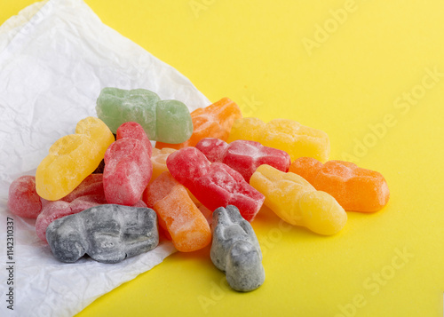 Colorful Jelly Babies on Yellow photo