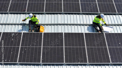 Wallpaper Mural Workers Installing Solar Panels on a Commercial Roof Under Bright Sunlight Torontodigital.ca