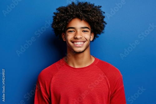 Happy Young Man Smiling Against Blue Background