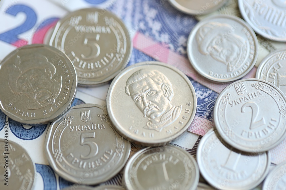 Ukraine money coins lying on mixed hryvnia banknotes. Finance background concept. Ukraine money coins lying on mixed hryvnia banknotes. Finance background concept.