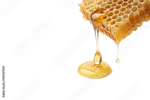 Honeycomb with honey drop isolated on White Background with Copy Space photo