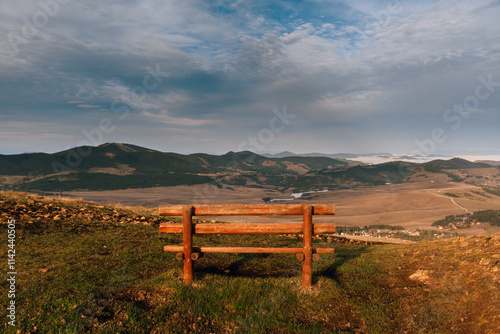 Empty Wooden Bench Overlooking Mountain Landscape