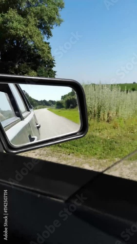 Wallpaper Mural Fast-moving car drives through a lush summer forest in Sumy region, Ukraine. Vertical 4k video, 52 seconds. Side mirror reflects a paved road and vibrant greenery, creating a dynamic perspective Torontodigital.ca