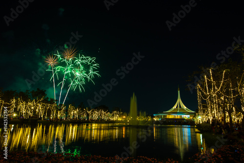 Colorful fireworks and light show at the Royal Park Suan Luang 2024 Flower Festival and the Rajamangala National Landmark building in Bangkok, Thailand photo