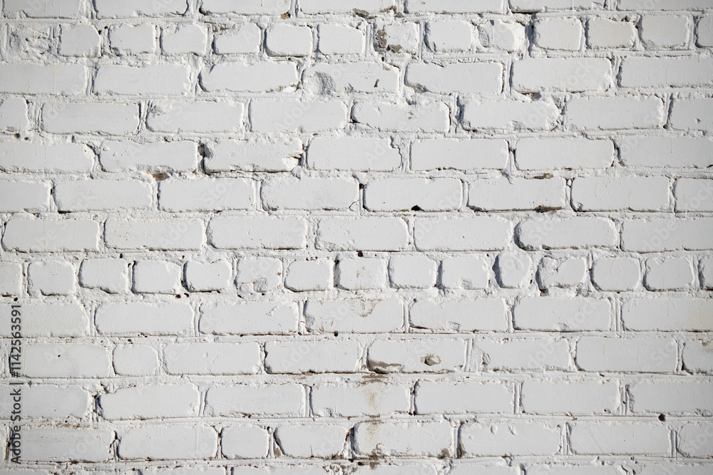 A white brick wall with a few cracks and a few spots A white brick wall with a few cracks and a few spots