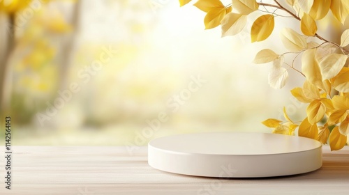 A serene setting featuring a round podium on a wooden surface, surrounded by soft yellow leaves and a blurred background, ideal for product displays, promotional materials, or seasonal themes, photo