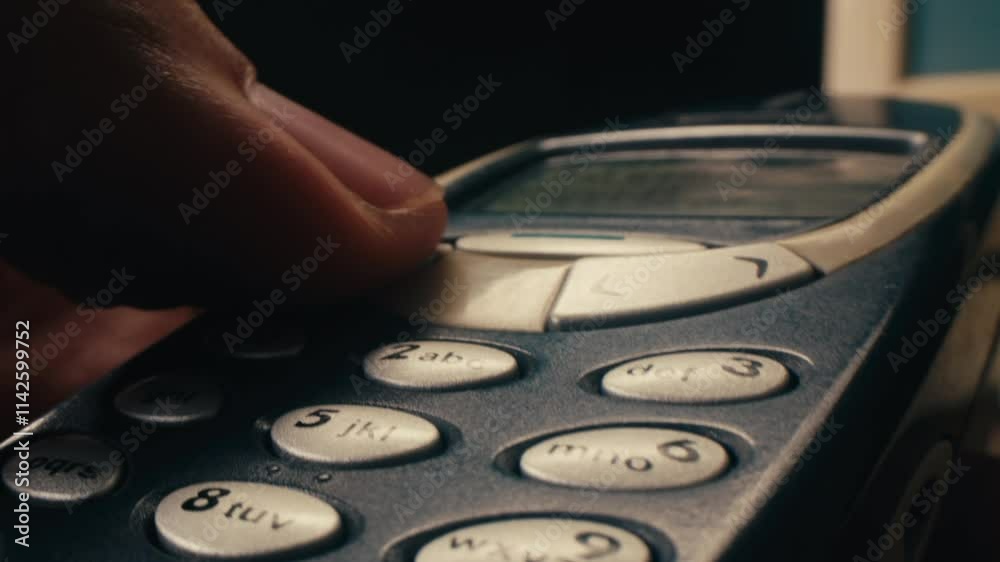 Man arm holding phone cellphone, vintage retro mobile phone, text message sms.