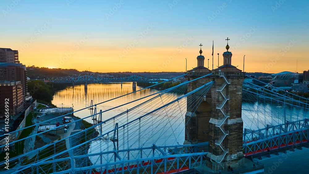 Fototapeta premium Aerial of John A Roebling Bridge at Sunset Over Ohio River