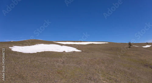 In some places there is snow in the mountains.