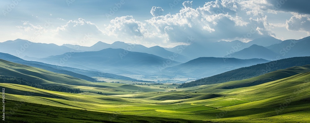 Valley meadow geography concept. Vast, serene landscape with rolling green hills and distant mountains under a cloudy sky. Valley meadow geography concept. Vast, serene landscape with rolling green hills and distant mountains under a cloudy sky.